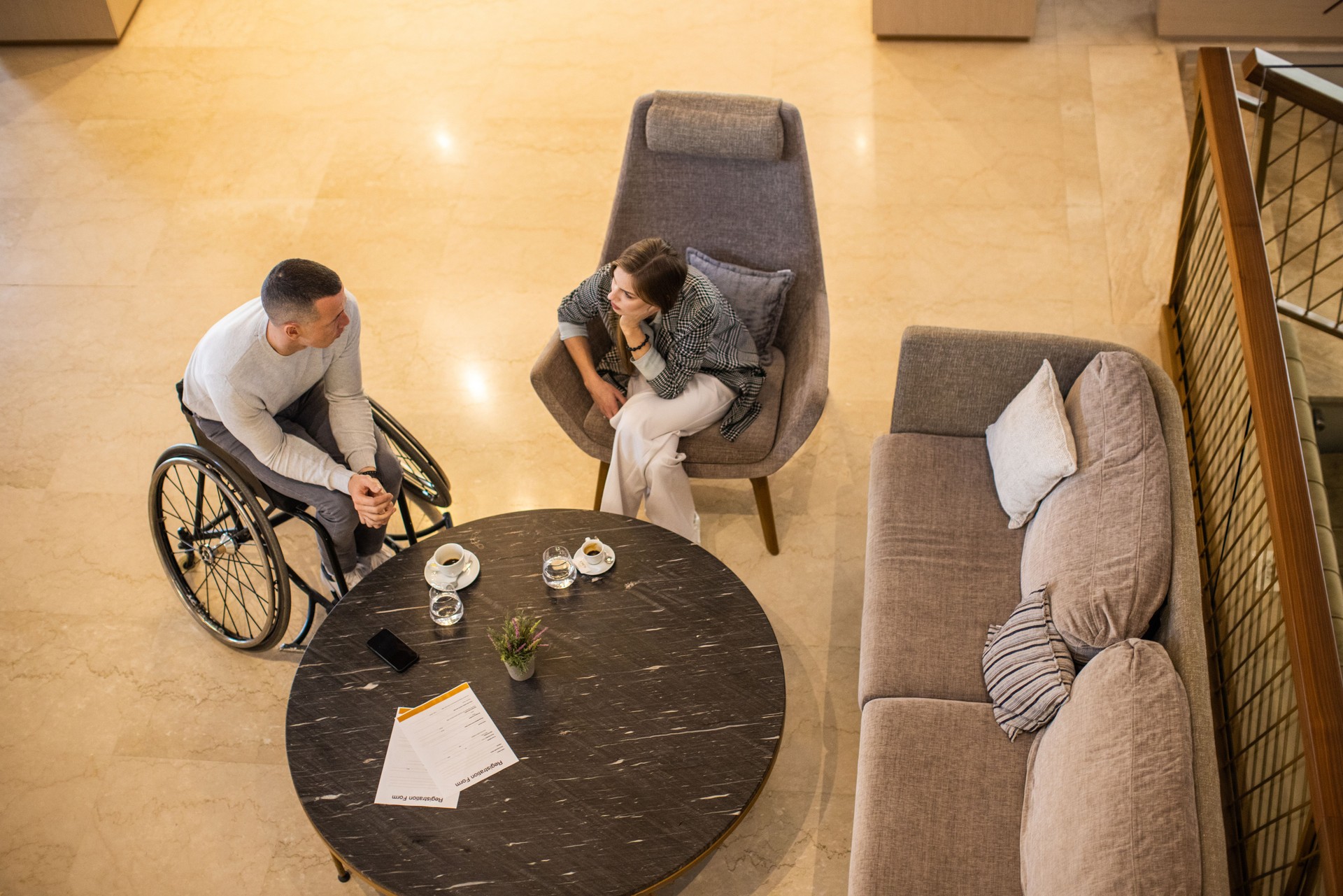 Disabled businessman talking with a business partner in a hotel lobby